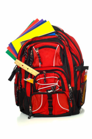Red school backpack or book bag stuffed full of folders and a variety of school supplies