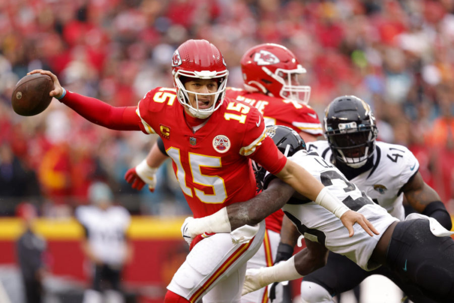 KANSAS CITY, MISSOURI - JANUARY 21: Patrick Mahomes #15 of the Kansas City Chiefs scrambles against Devin Lloyd #33 of the Jacksonville Jaguars during the first quarter in the AFC Divisional Playoff game at Arrowhead Stadium on January 21, 2023 in Kansas City, Missouri. (Photo by David Eulitt/Getty Images)