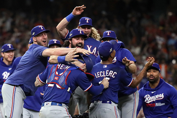 HOUSTON, TEXAS - OCTOBER 23: Jose Leclerc #25 of the Texas Rangers celebrates with Jonah Heim #28 after defeating the Houston Astros in Game Seven to win the American League Championship Series at Minute Maid Park on October 23, 2023 in Houston, Texas. (Photo by Bob Levey/Getty Images)