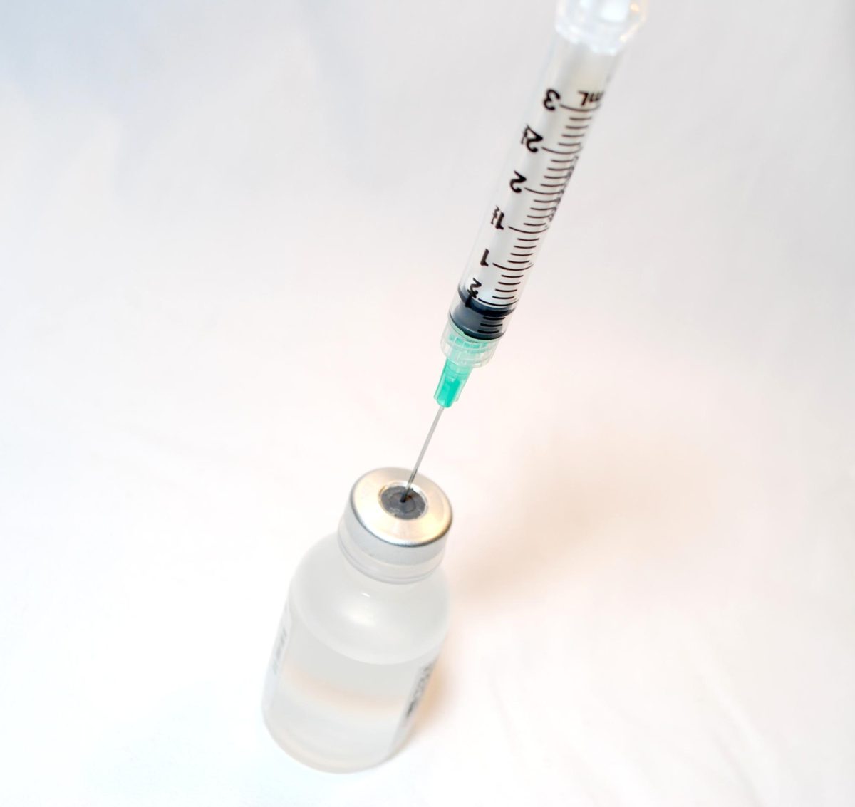 Needle syringe with a vaccine bottle, credit NIH